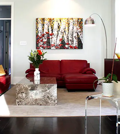 A living room with red couches and a table