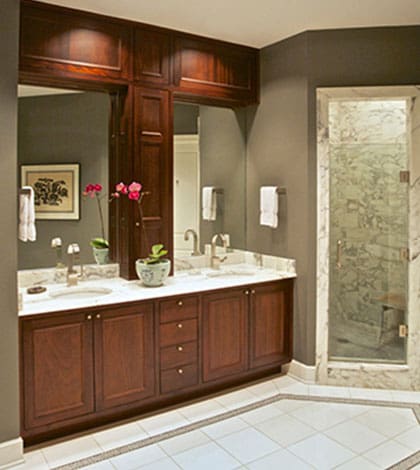 A bathroom with two sinks and a large mirror.